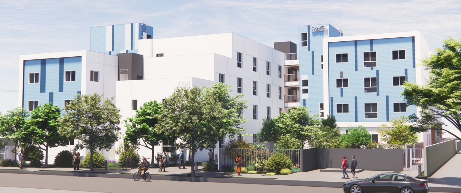 Modern four-story building with white and blue exterior, surrounded by trees and landscaping. People walk and ride bikes along the sidewalk in front of the building, which has a sign reading Daniels Village..