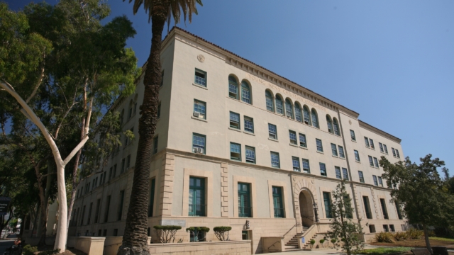 Centennial Place exterior from lawn, arched entranceway and arched top-level windows