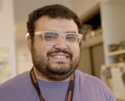 Ian with glasses smiling at camera