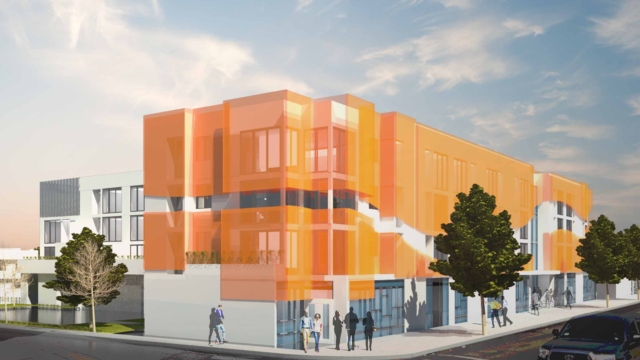 Coming Soon: Manchester Urban Homes. Corner angle of building with orange facade and people gathering at the ground level.