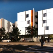 Now Leasing: The Carlton, a multifamily building with three and four levels above grade. White and orange exterior.