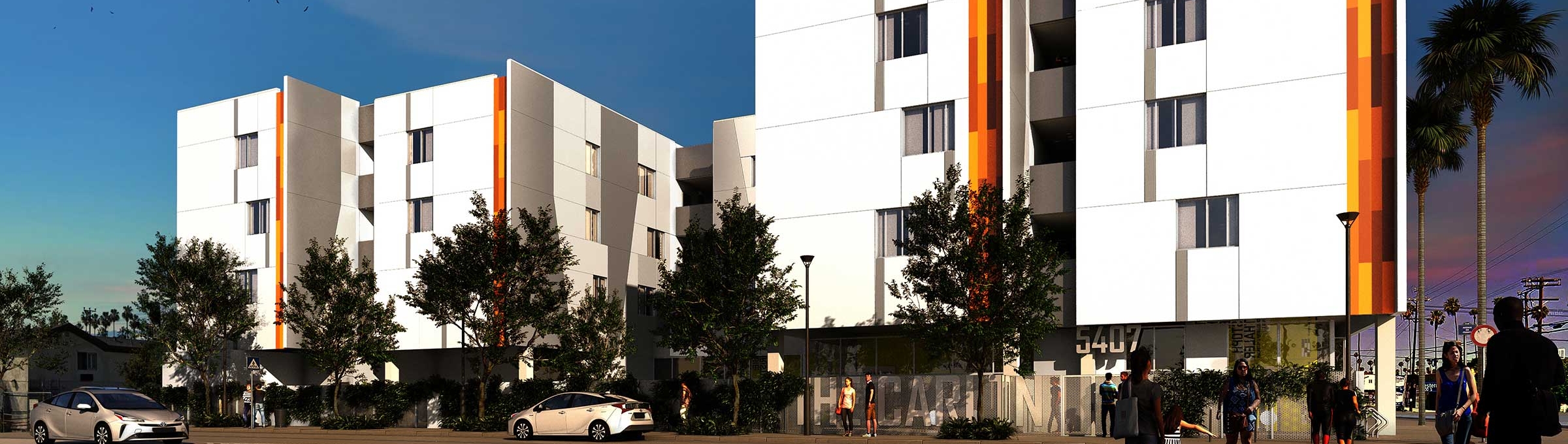Now Leasing: The Carlton, a multifamily building with three and four levels above grade. White and orange exterior.