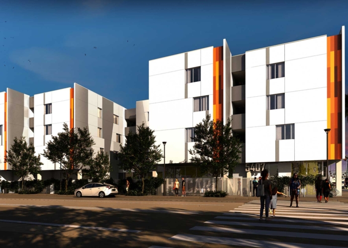 Now Leasing: The Carlton, a multifamily building with three and four levels above grade. White and orange exterior.